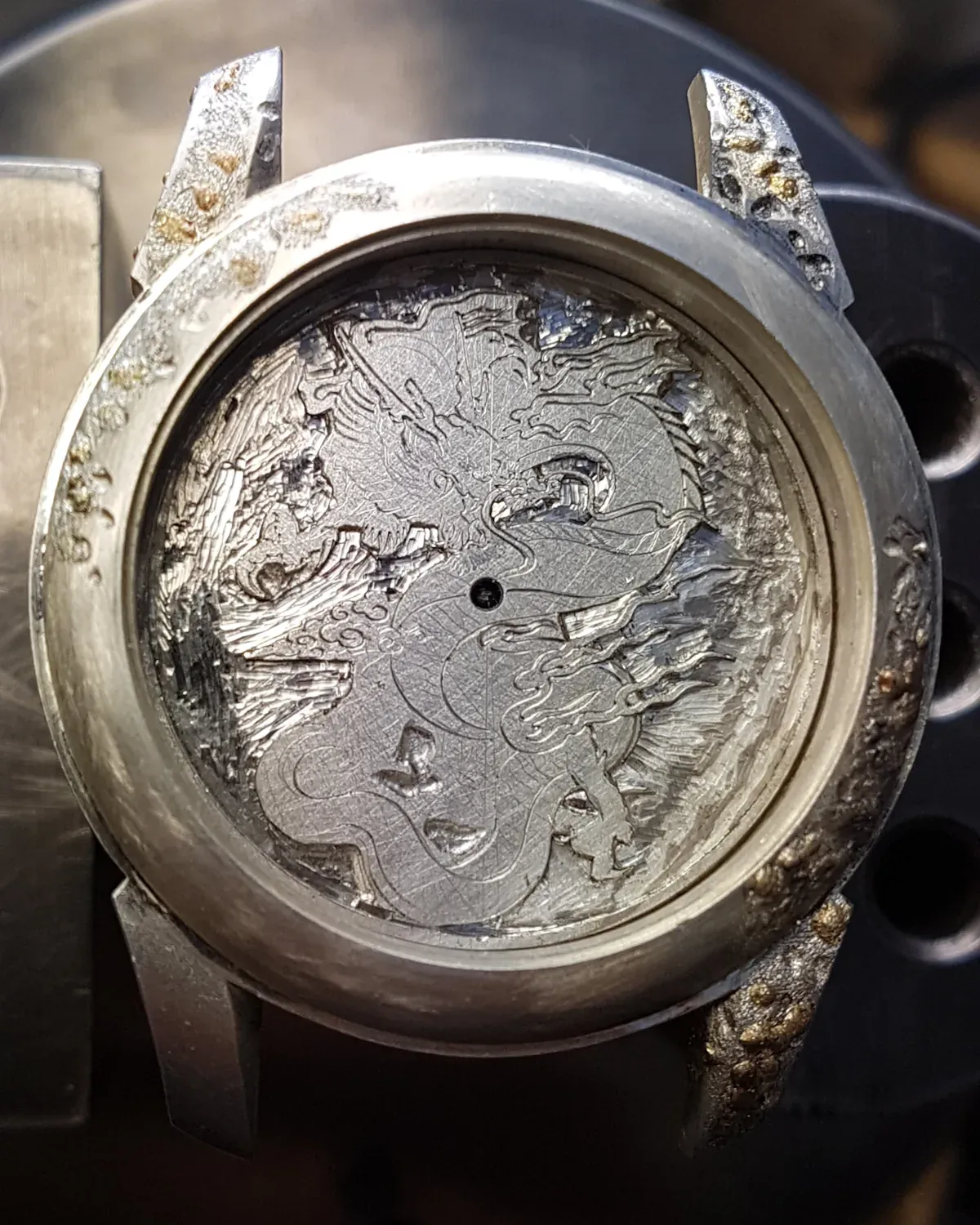 The first engraved lines outlining the design on metal