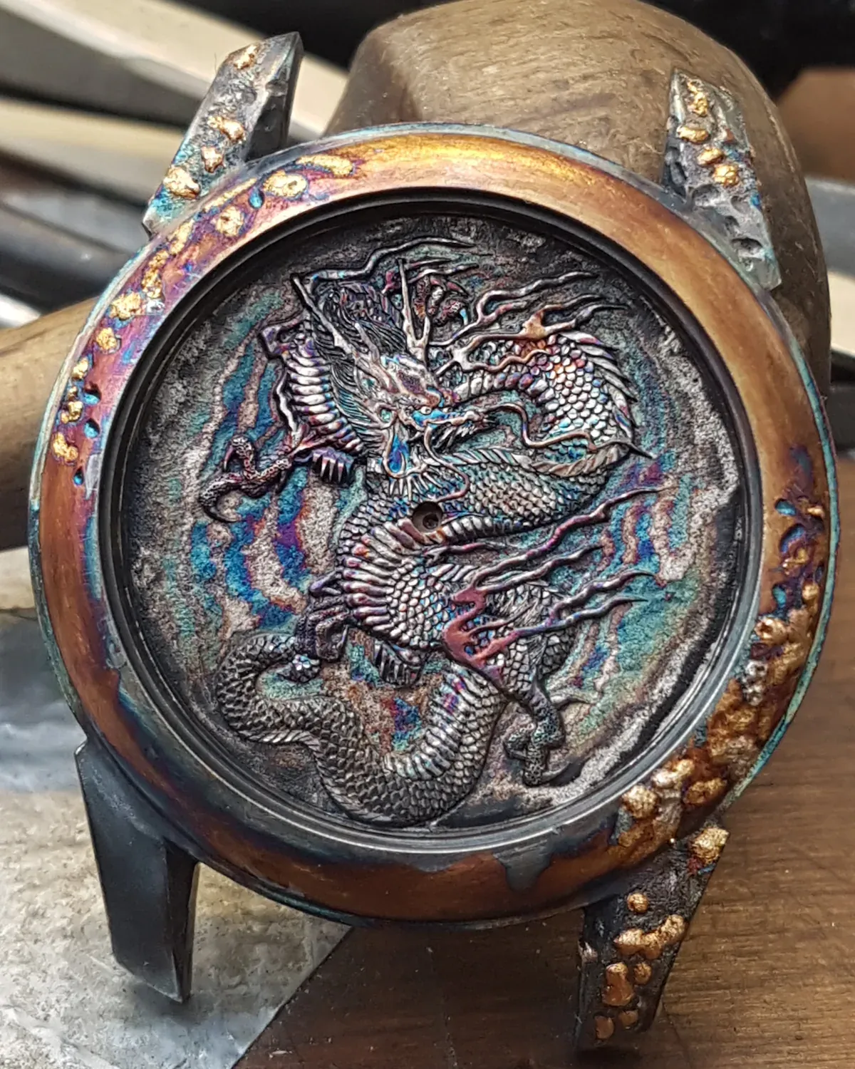 Oxidation bringing out purple, blue and green tones on the metal